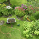 A summer garden with flowers and tools.