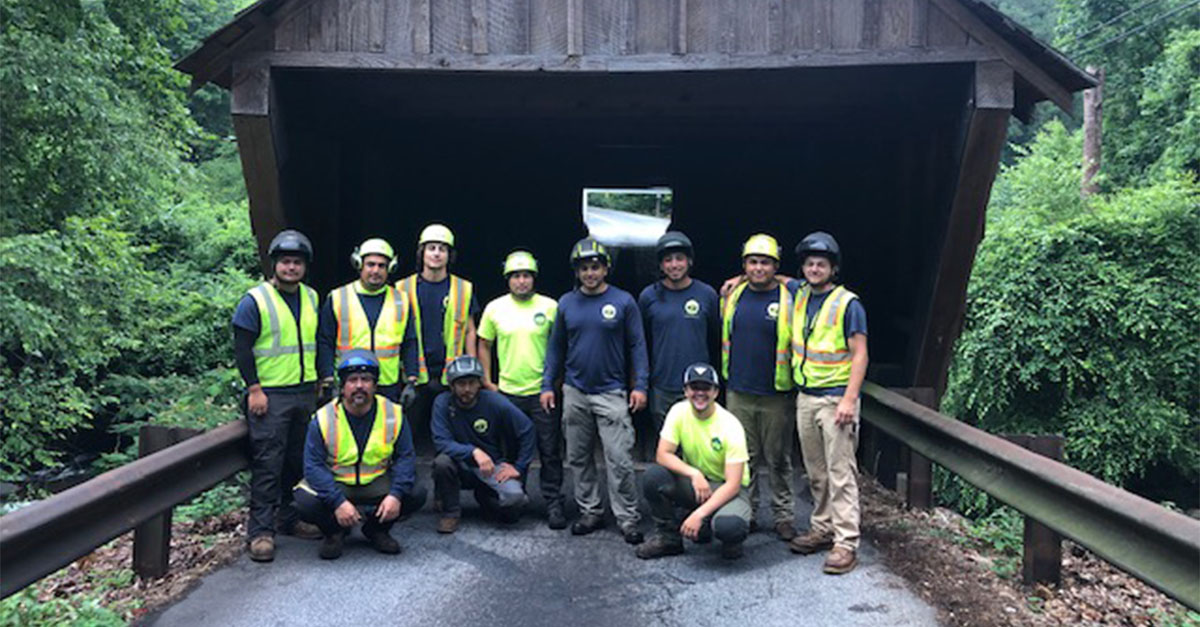 Premier Tree Solutions team under the Concord Covered Bridge.