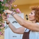 A woman pruning a tree.